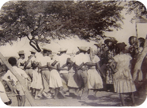 The Simadan (Harvest) Dance, notice the base's U.S. Flag in the upper right corner. Image courtesy of Tanki Maraka Heritage Park.